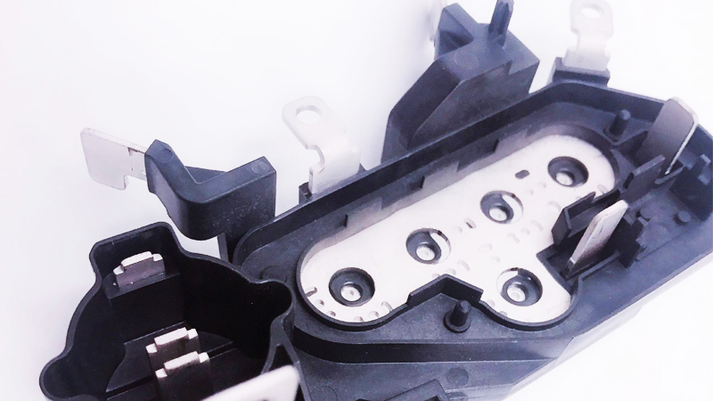 Insert molding involves embedding a pre-formed part (the “insert”)—such as a metal fastener, electronic component, or ceramic substrate—into molten plastic during injection molding.