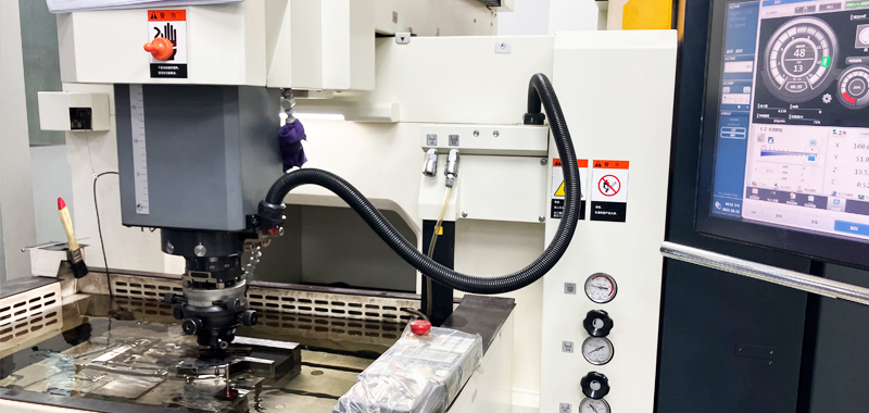 Makino sinker EDM machine performing precision electrical discharge machining on a hardened steel mold cavity