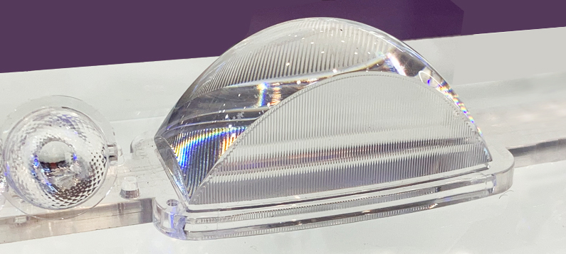 Optical lens molded with POLMAX steel showing flawless surface under light scattering inspection